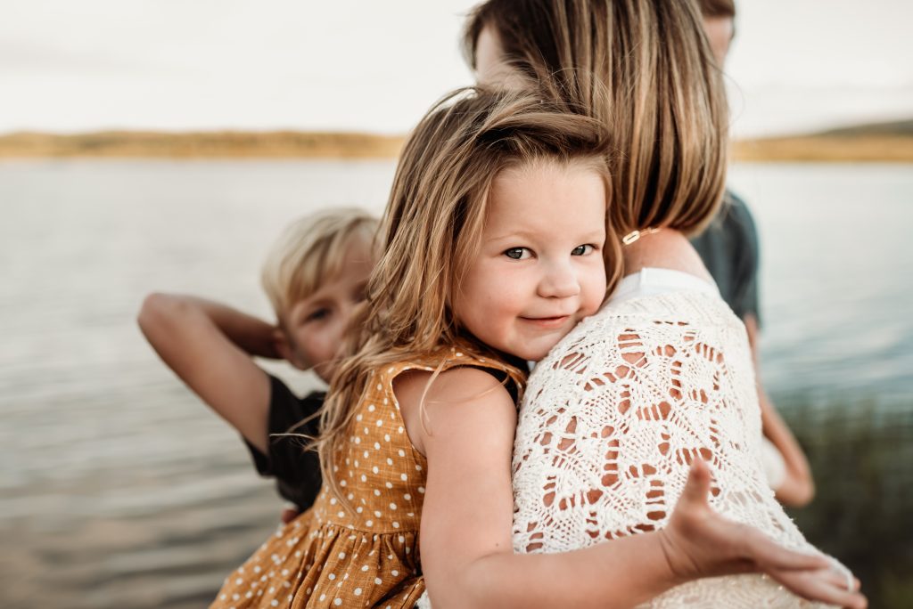 Two dental patients smile and show off their white teeth.